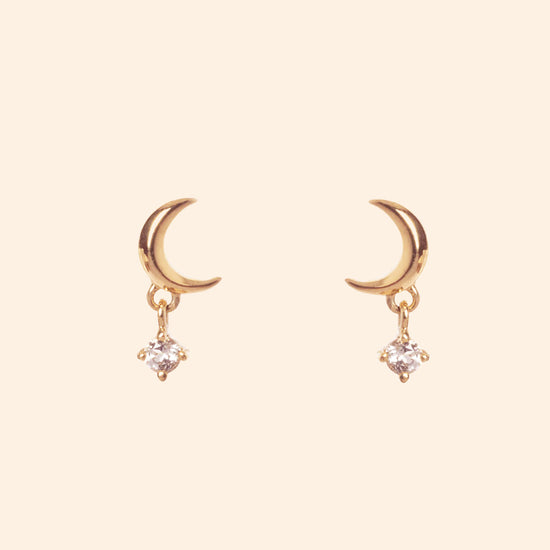 Front view of 14k gold vermeil Crescent Moon Studs, featuring a gold crescent moon and diamond drop, styled for a curated ear stack from the Celestial collection by LIRAE.