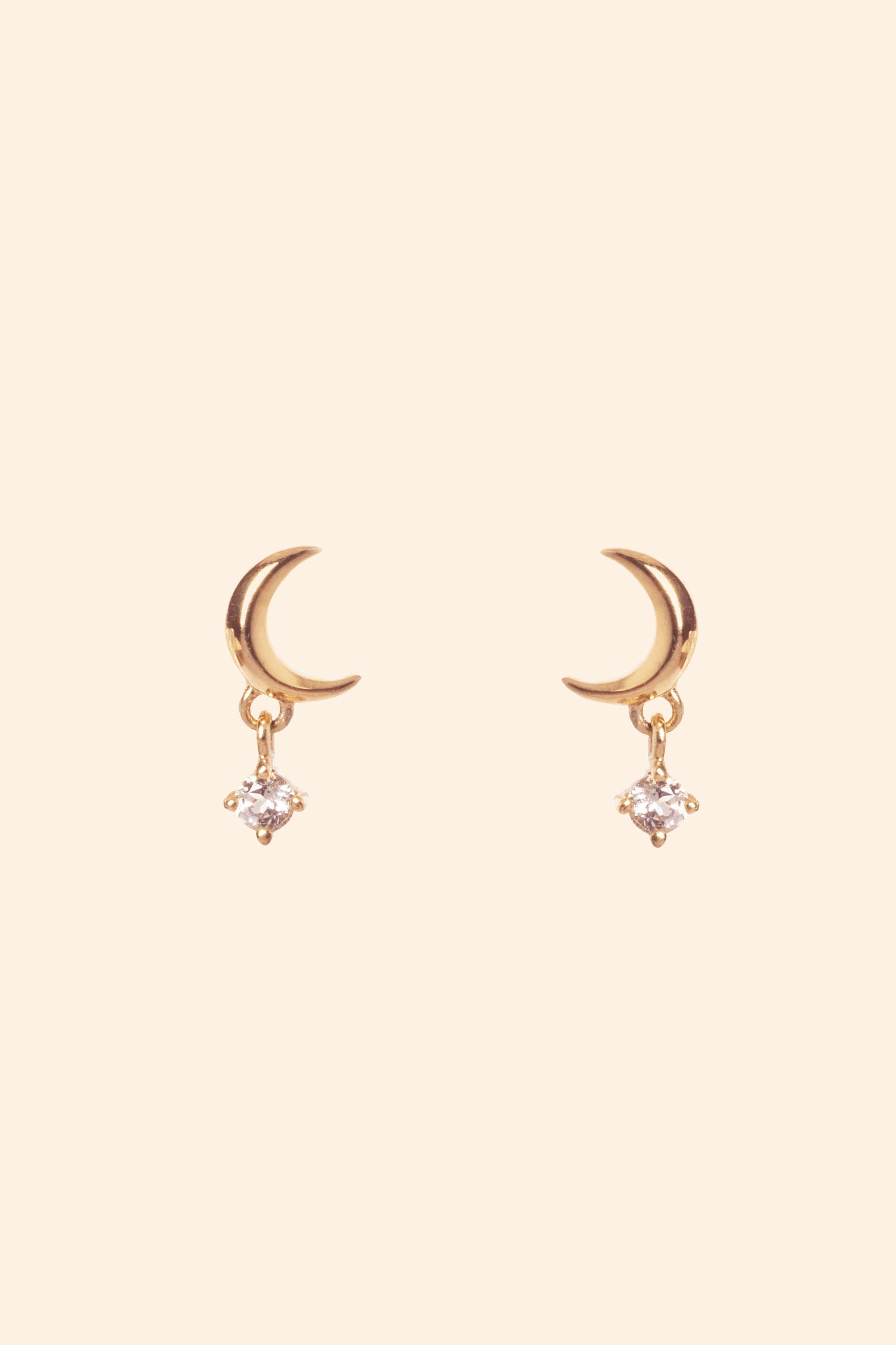 Front view of 14k gold vermeil Crescent Moon Studs, featuring a gold crescent moon and diamond drop, styled for a curated ear stack from the Celestial collection by LIRAE.