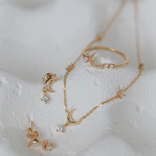 Dainty gold crescent moon necklace with sparkling moissanite stations