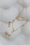 Dainty gold crescent moon necklace with sparkling moissanite stations