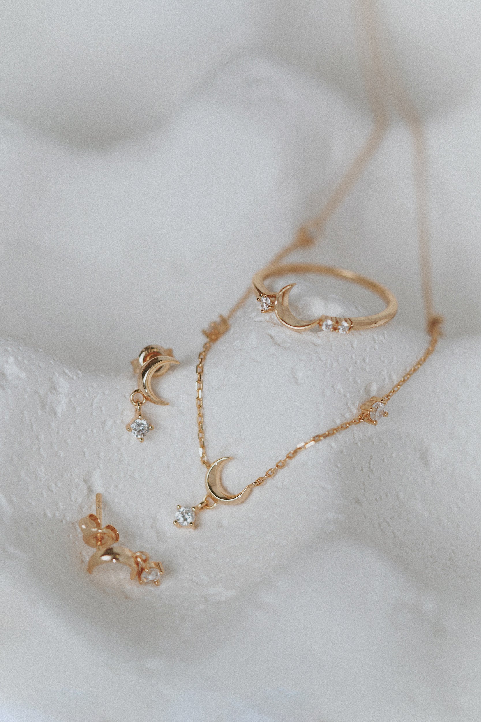 Dainty gold crescent moon necklace with sparkling moissanite stations