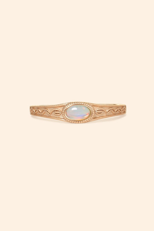 Vintage-style 14k gold plated ring with intricate wave scroll engravings and an oval opal cabochon, handcrafted ancient relic jewelry by LIRAE.