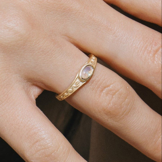 Vintage-style 14k gold plated ring with intricate wave scroll engravings and an oval opal cabochon, handcrafted ancient relic jewelry by LIRAE.