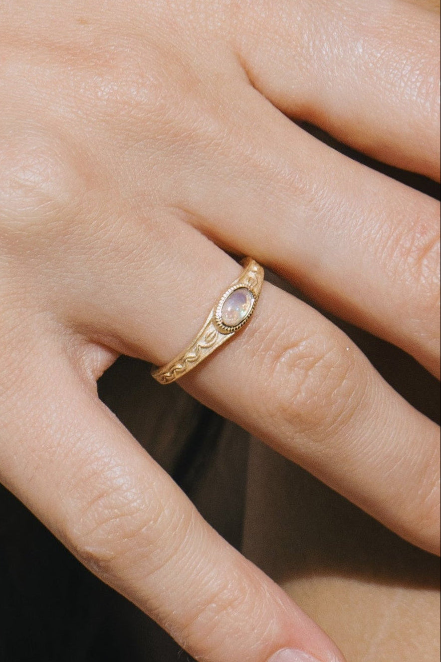 Vintage-style 14k gold plated ring with intricate wave scroll engravings and an oval opal cabochon, handcrafted ancient relic jewelry by LIRAE.