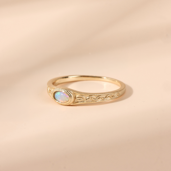 Vintage-style 14k gold plated ring with intricate wave scroll engravings and an oval opal cabochon, handcrafted ancient relic jewelry by LIRAE.