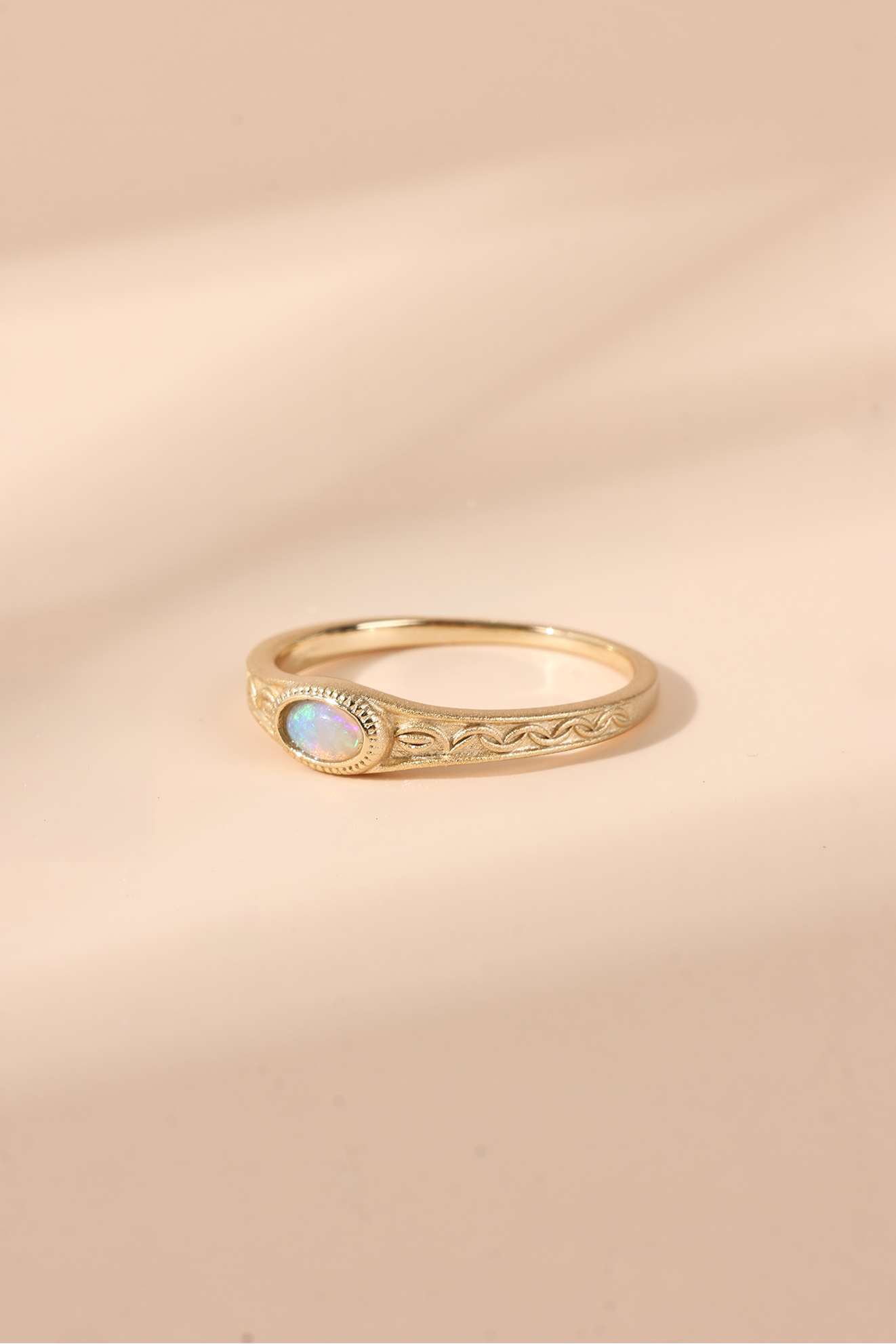 Vintage-style 14k gold plated ring with intricate wave scroll engravings and an oval opal cabochon, handcrafted ancient relic jewelry by LIRAE.
