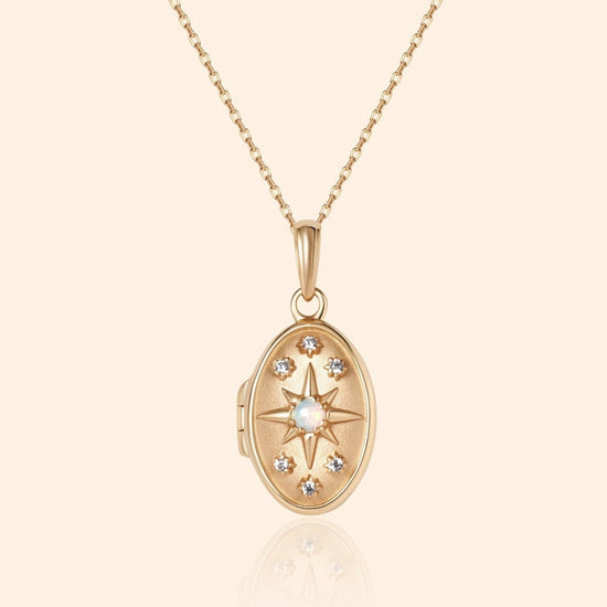 Gold oval opal locket necklace with celestial compass star and moissanite details