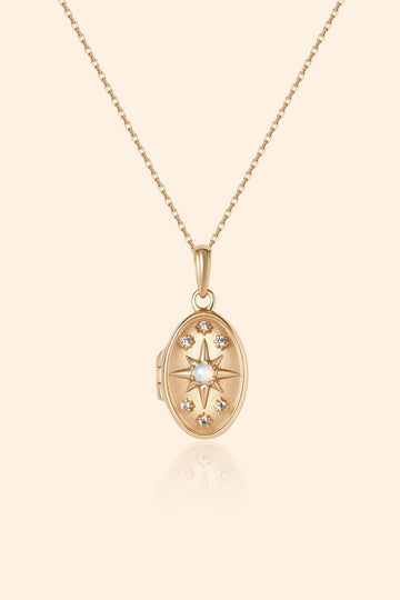 Gold oval opal locket necklace with celestial compass star and moissanite details