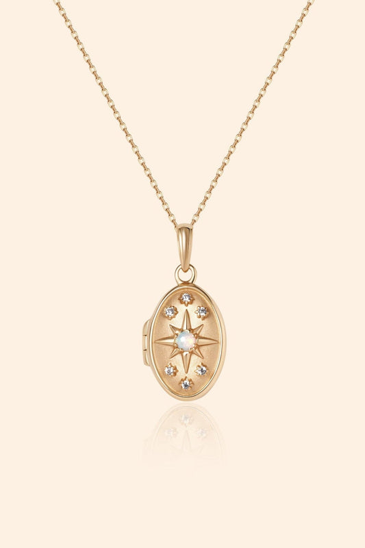 Gold oval opal locket necklace with celestial compass star and moissanite details