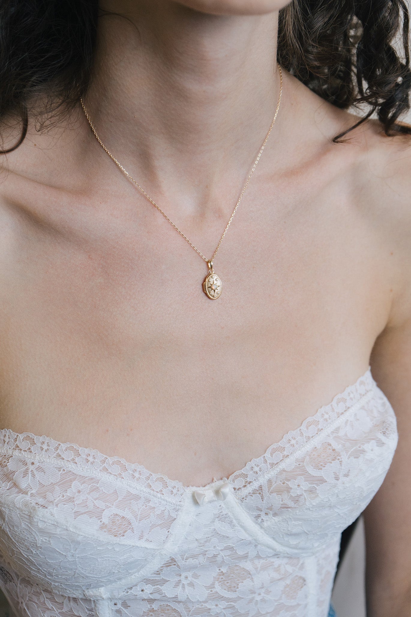 Gold oval opal locket necklace with celestial compass star and moissanite details