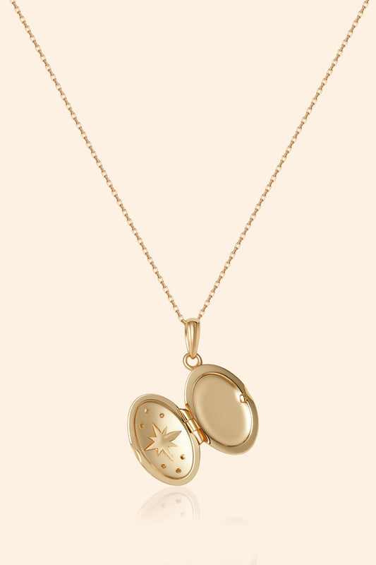 Gold oval opal locket necklace with celestial compass star and moissanite details