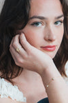 Dainty gold celestial compass ring with oval starburst design and sparkling accents