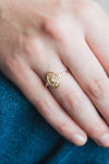 Dainty gold celestial compass ring with oval starburst design and sparkling accents