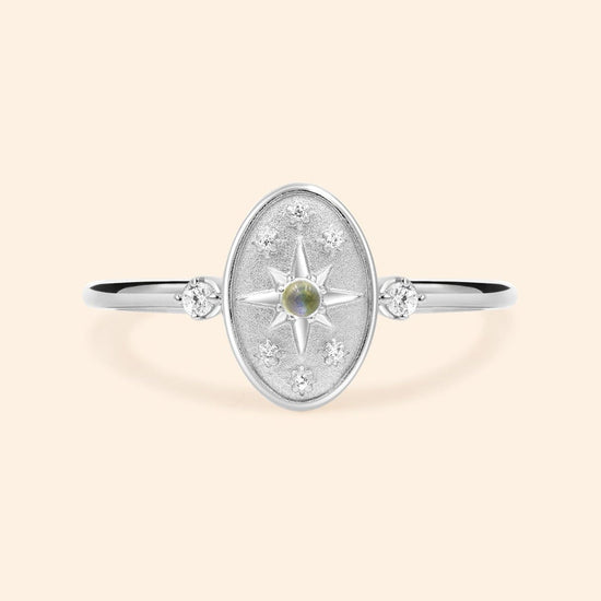 Dainty silver celestial compass ring with oval starburst design and sparkling accents