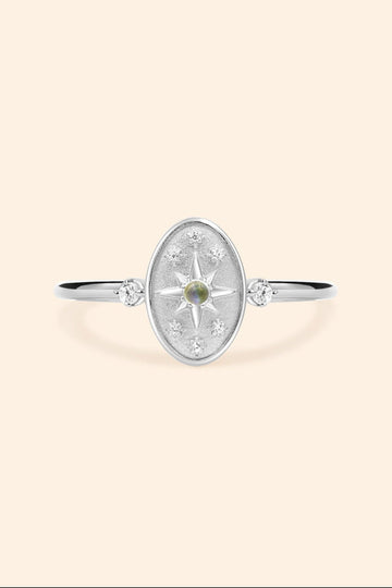 Dainty silver celestial compass ring with oval starburst design and sparkling accents