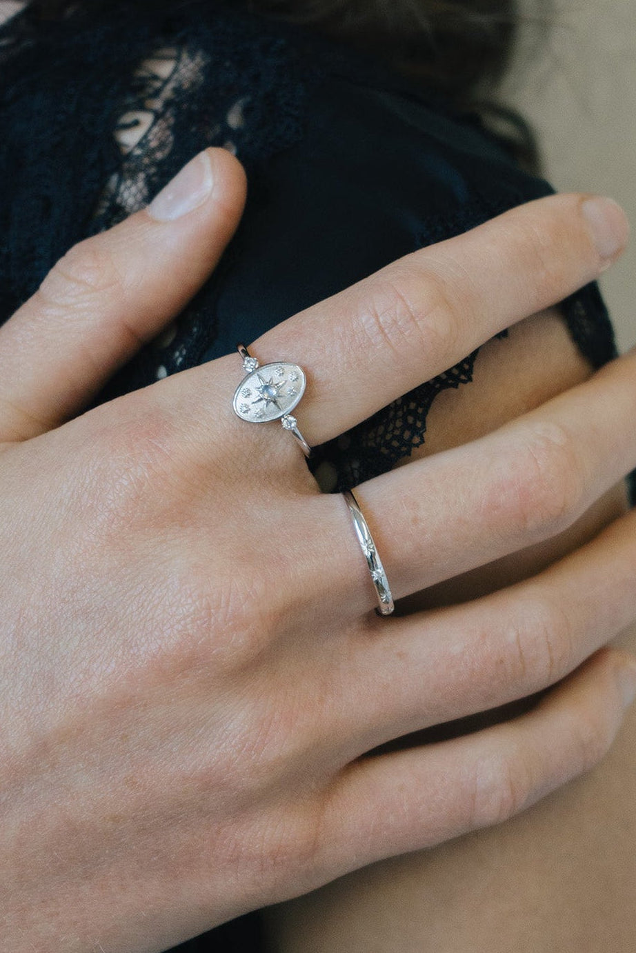 Dainty silver celestial compass ring with oval starburst design and sparkling accents