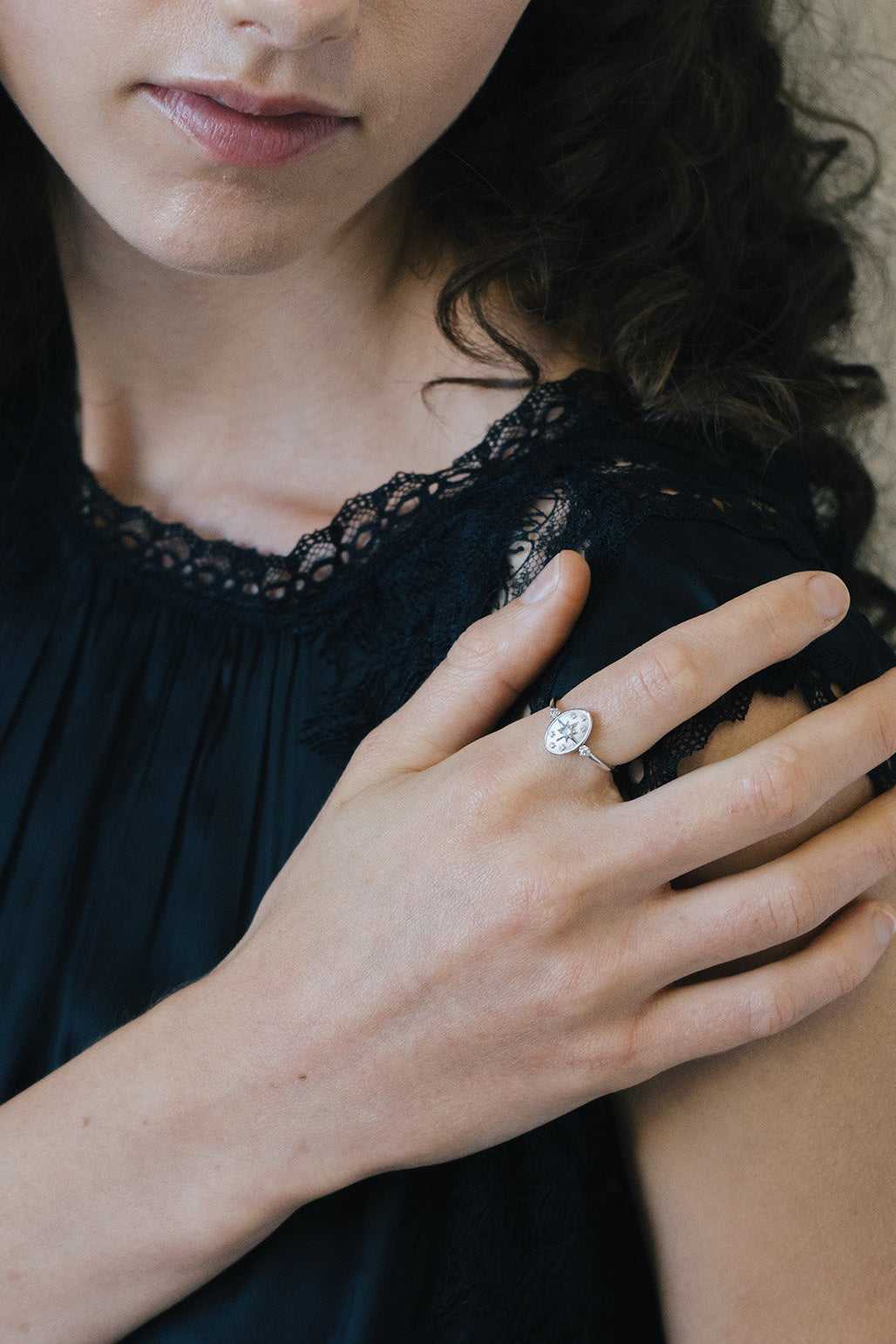 Dainty silver celestial compass ring with oval starburst design and sparkling accents