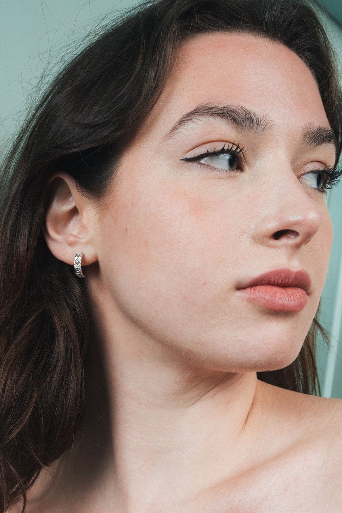 Silver solstice hoop earrings featuring fire opals and celestial starburst engravings by LIRAE.