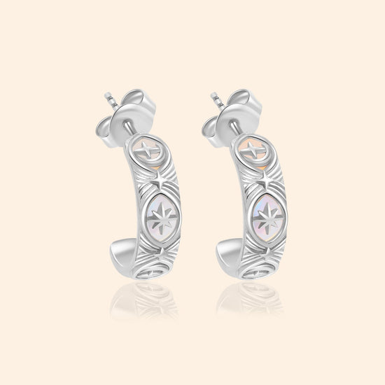 Silver solstice hoop earrings featuring fire opals and celestial starburst engravings by LIRAE.