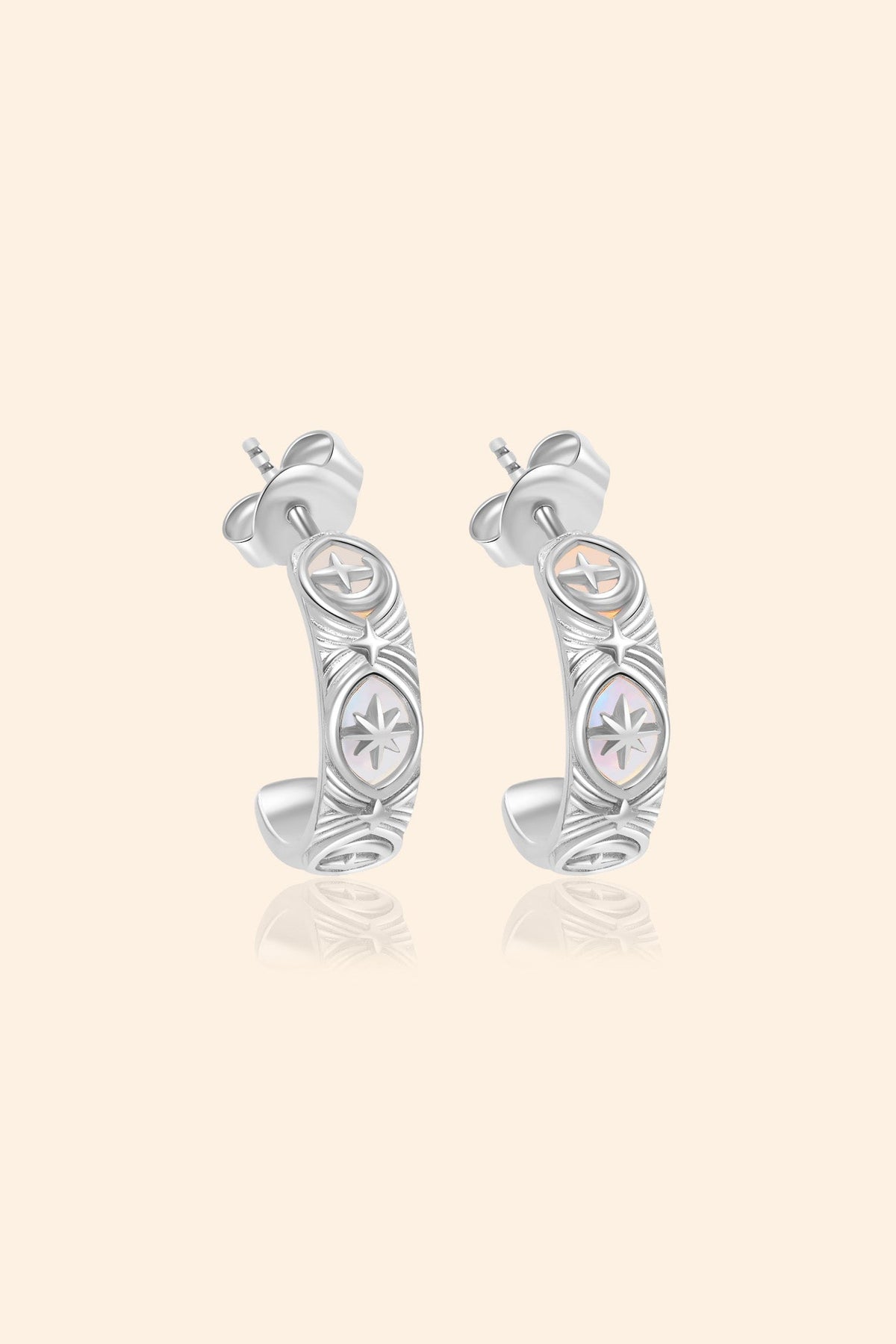 Silver solstice hoop earrings featuring fire opals and celestial starburst engravings by LIRAE.