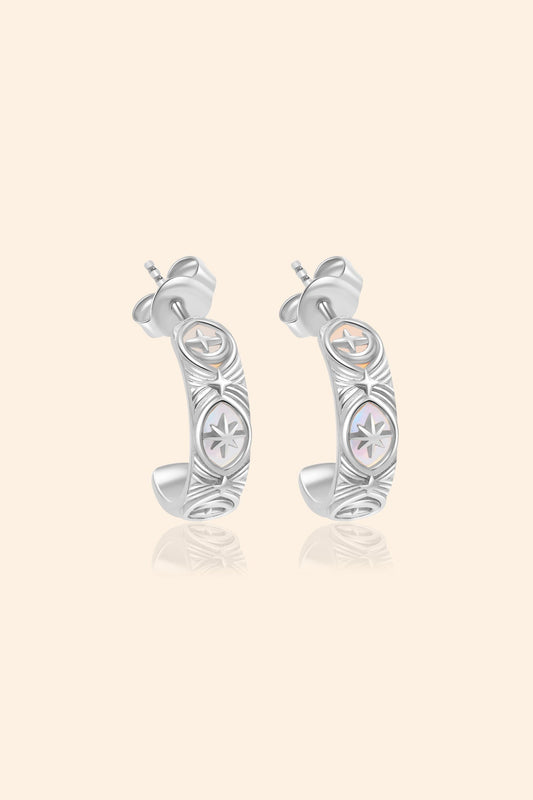 Silver solstice hoop earrings featuring fire opals and celestial starburst engravings by LIRAE.