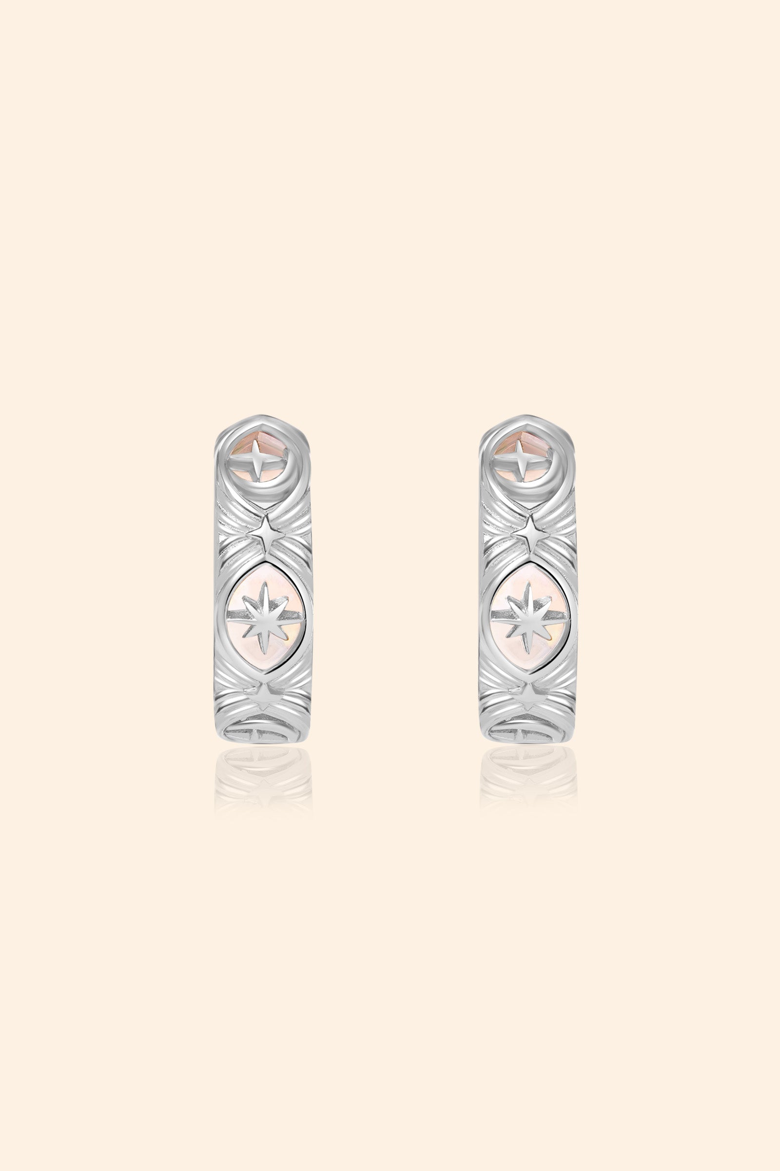 Silver solstice hoop earrings featuring fire opals and celestial starburst engravings by LIRAE.