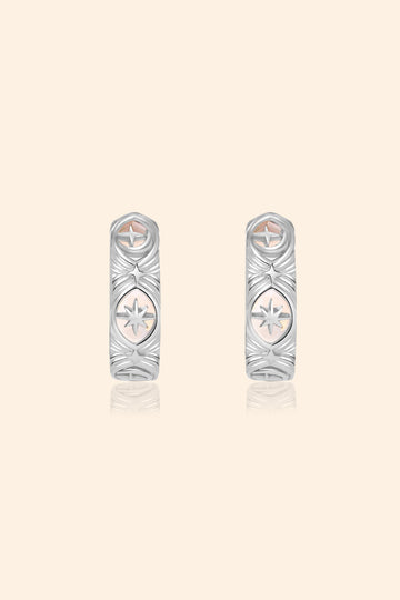 Silver solstice hoop earrings featuring fire opals and celestial starburst engravings by LIRAE.