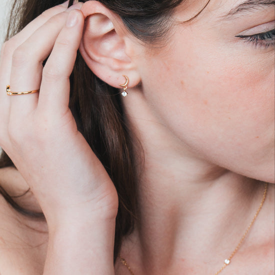 Dainty gold crescent moon necklace with sparkling moissanite stations