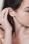 Dainty gold crescent moon necklace with sparkling moissanite stations