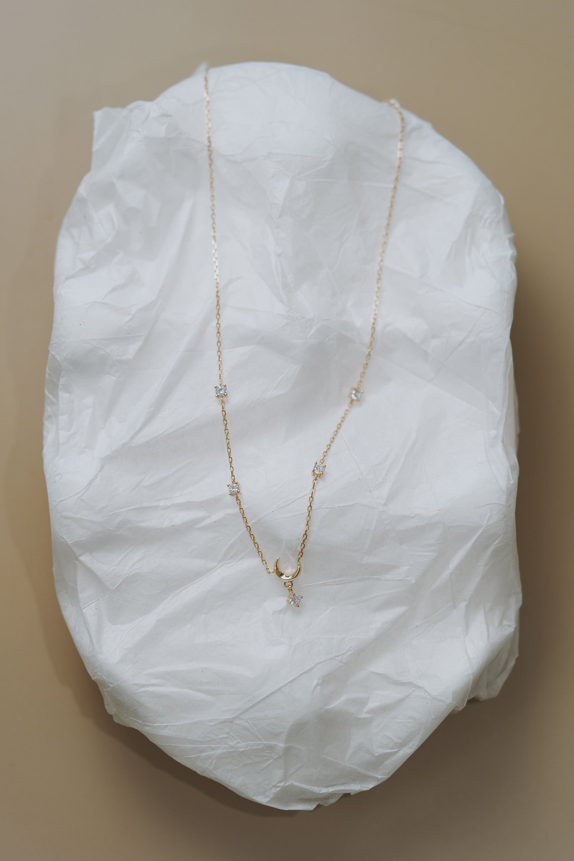 Dainty gold crescent moon necklace with sparkling moissanite stations