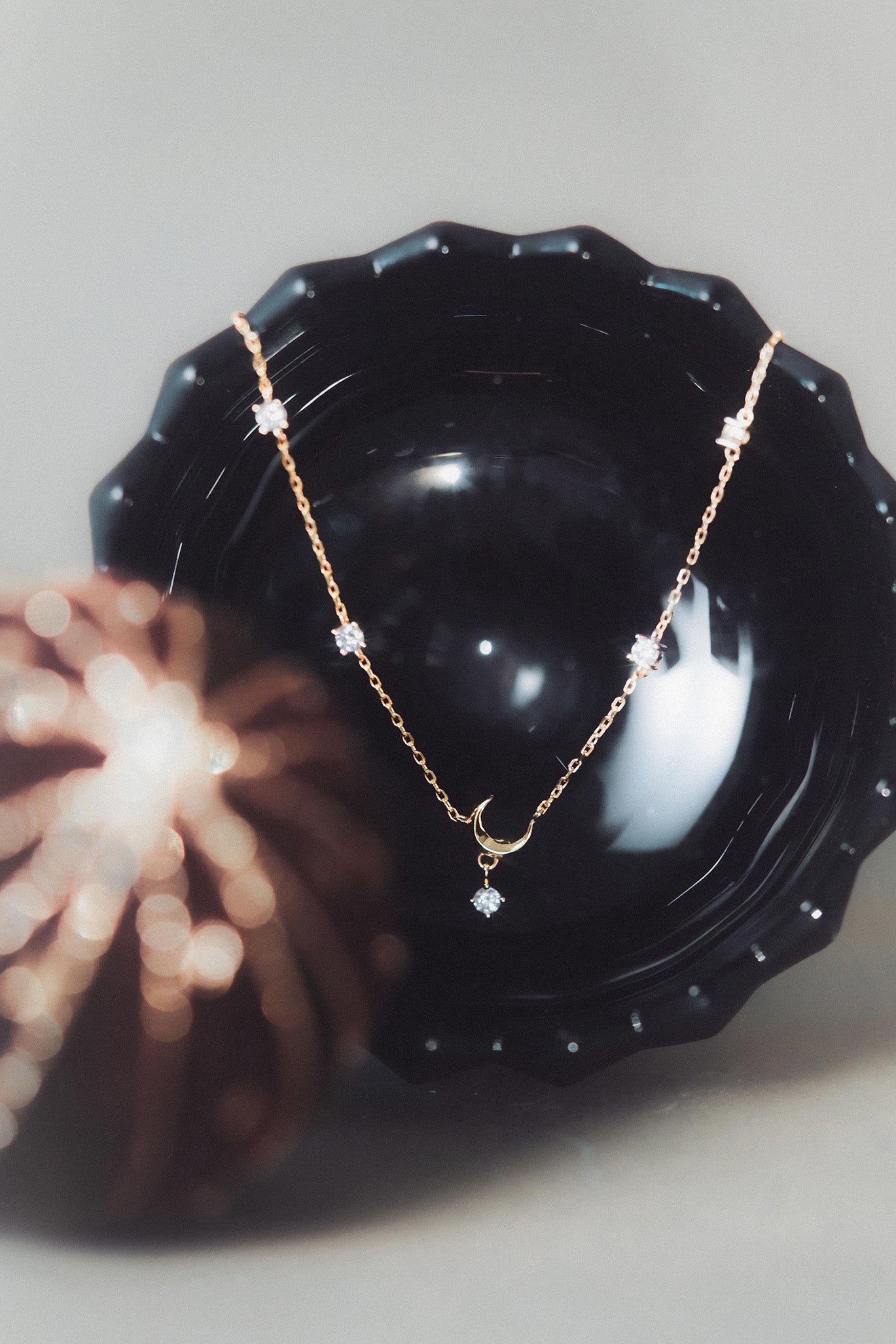Dainty gold crescent moon necklace with sparkling moissanite stations