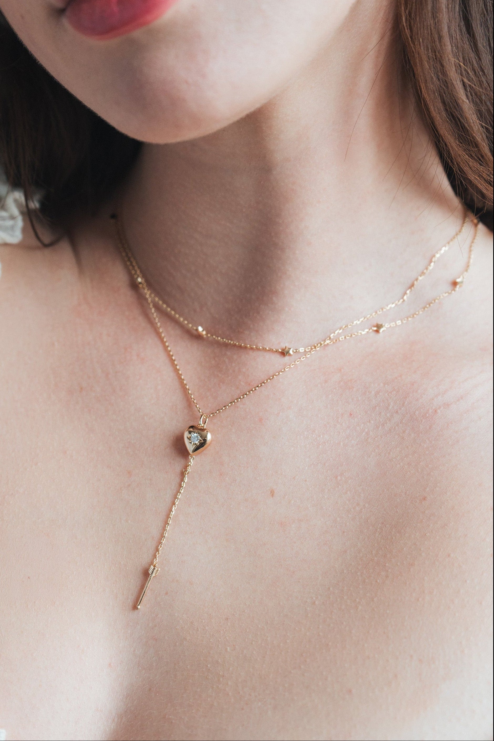 Gold heart arrow necklace with removable arrow and sparkling center moissanite stone