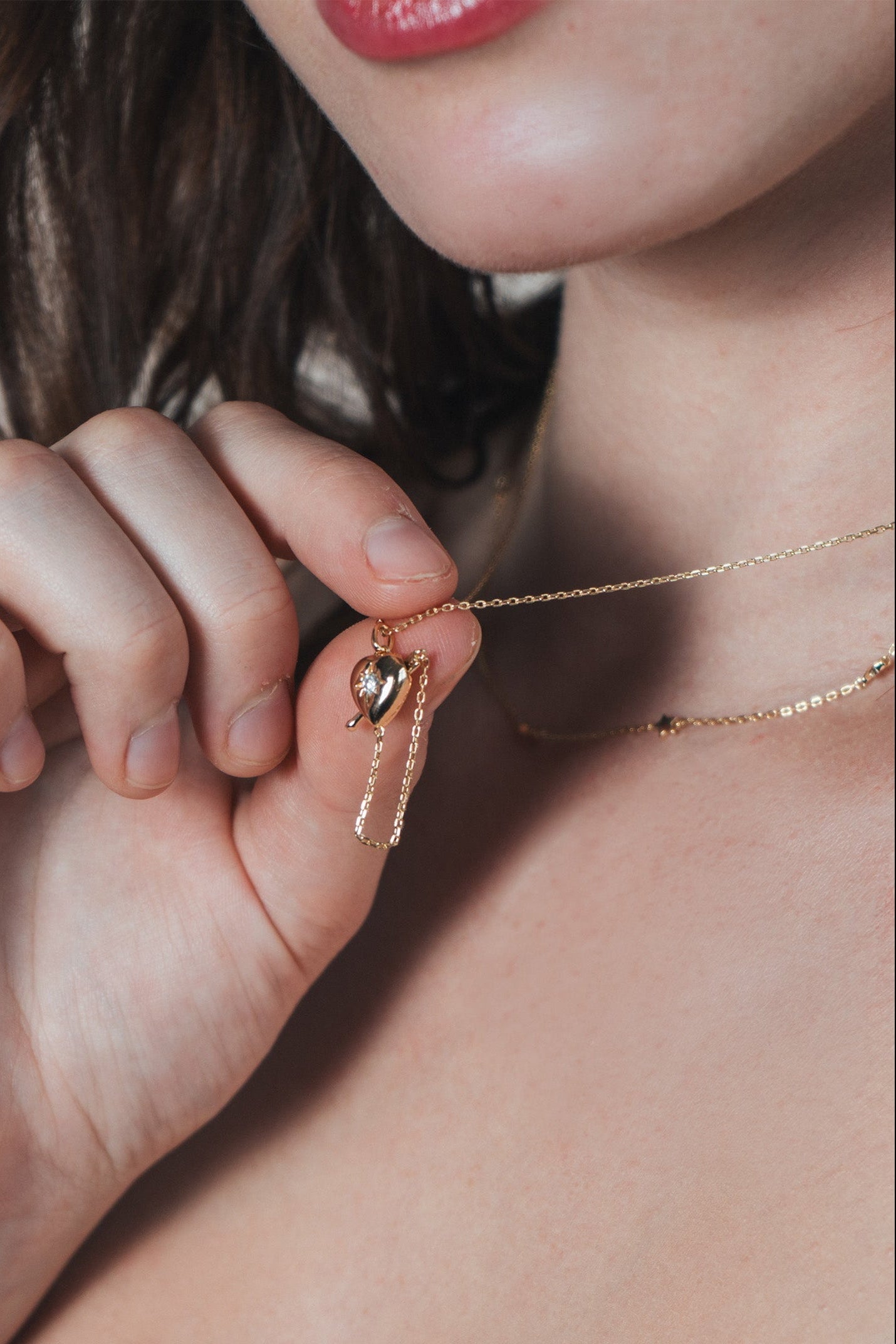 Gold heart arrow necklace with removable arrow and sparkling center moissanite stone