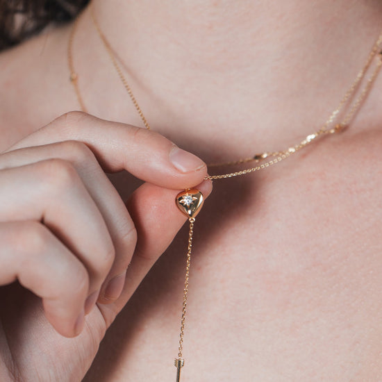Gold heart arrow necklace with removable arrow and sparkling center moissanite stone