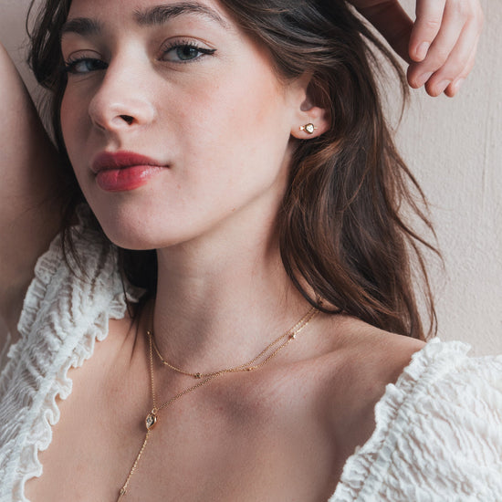 Gold heart arrow necklace with removable arrow and sparkling center moissanite stone