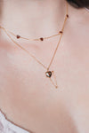 Gold heart charm necklace with removable arrow and red heart garnet center stone
