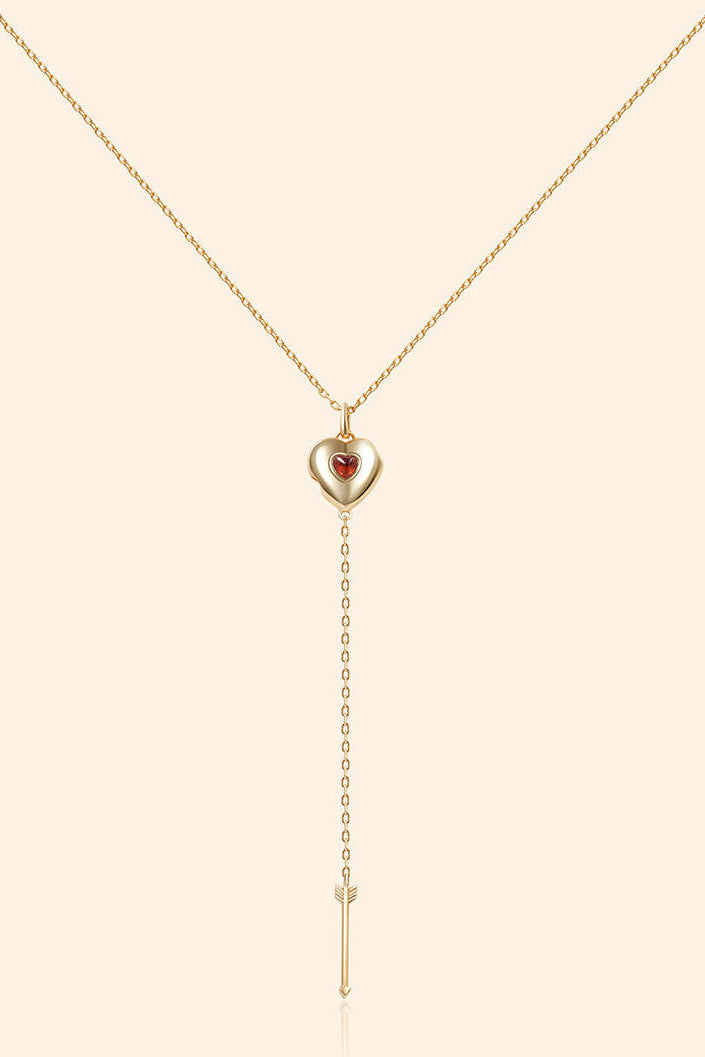 Gold heart charm necklace with removable arrow and red heart garnet center stone