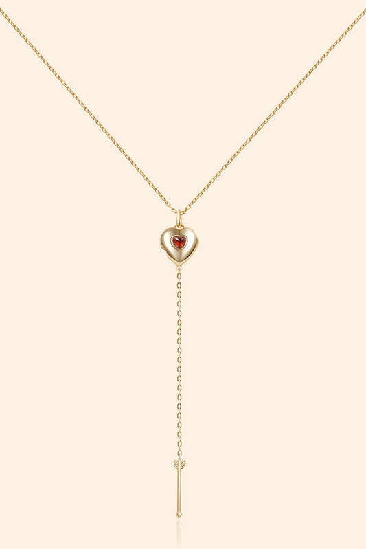 Gold heart charm necklace with removable arrow and red heart garnet center stone
