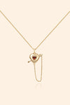 Gold heart charm necklace with removable arrow and red heart garnet center stone