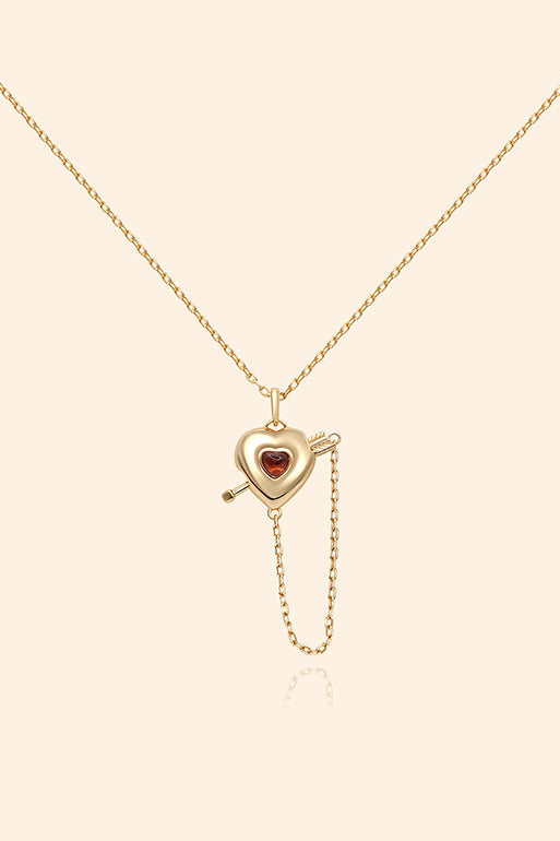 Gold heart charm necklace with removable arrow and red heart garnet center stone