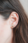 Dainty gold heart stud earrings with arrow details and sparkling center moissanite stones