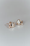 Dainty gold heart stud earrings with arrow details and sparkling center moissanite stones