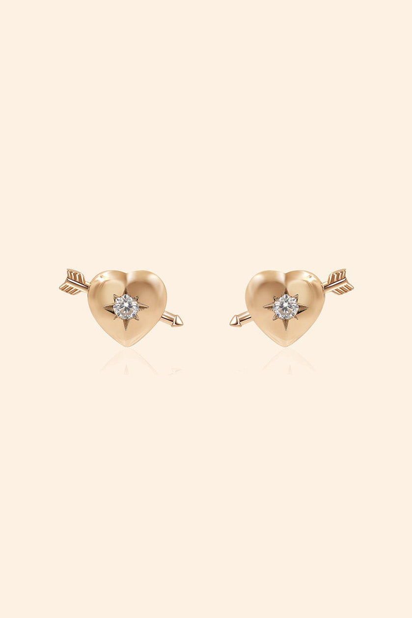 Dainty gold heart stud earrings with arrow details and sparkling center moissanite stones