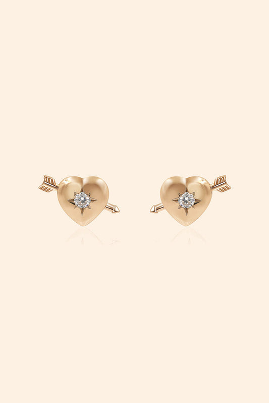 Dainty gold heart stud earrings with arrow details and sparkling center moissanite stones