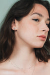 Dainty silver heart stud earrings with arrow details and sparkling center moissanite stones