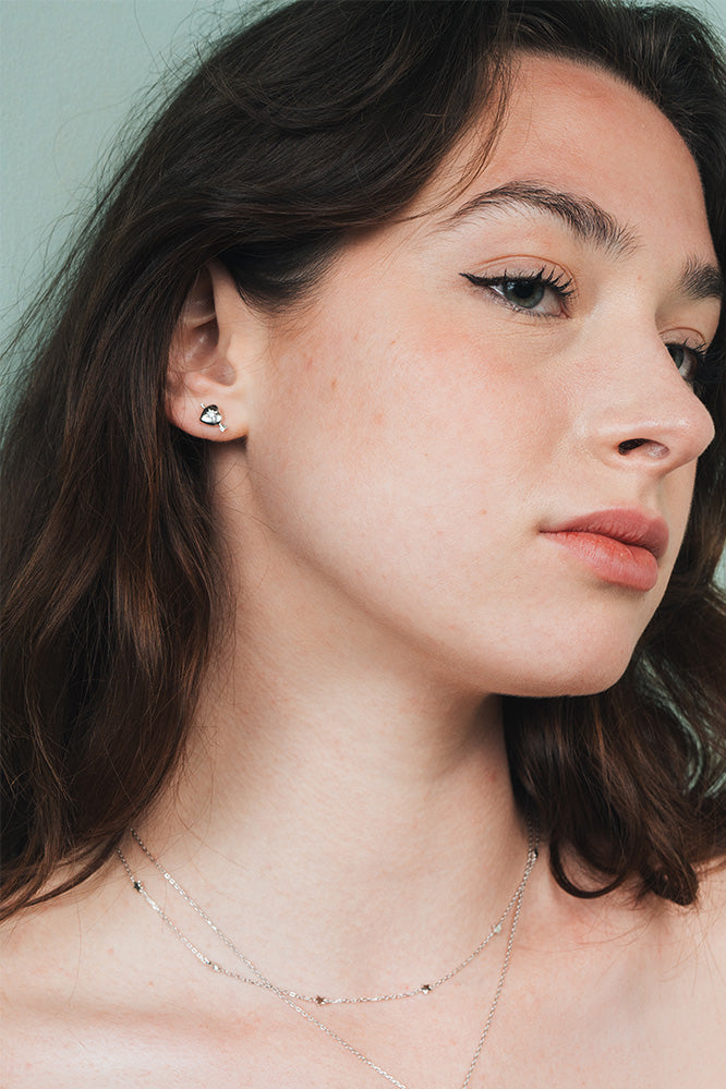 Dainty silver heart stud earrings with arrow details and sparkling center moissanite stones