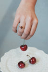 Dainty gold ring with emerald-cut garnet and sparkling moissanite accents
