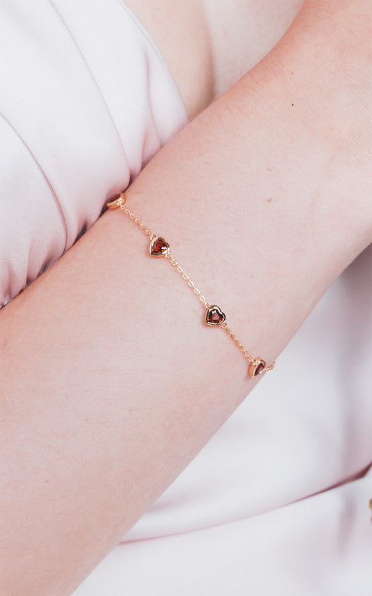 Dainty gold heart station bracelet with red heart-shaped stones