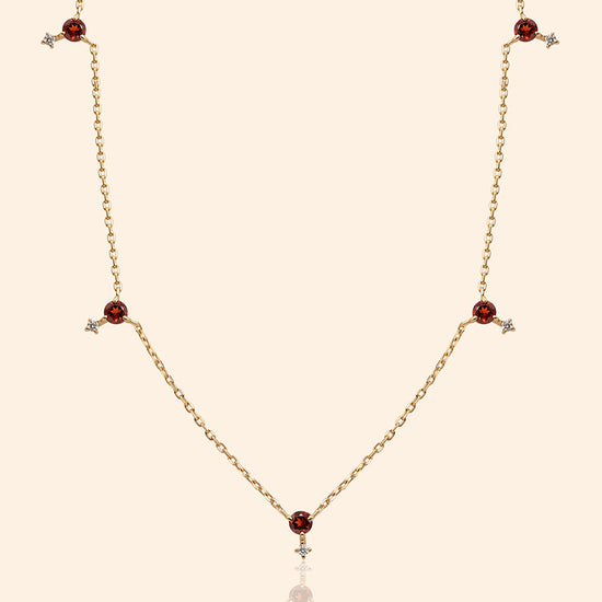 Dainty gold garnet station necklace with sparkling moissanite star accents