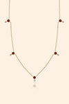 Dainty gold garnet station necklace with sparkling moissanite star accents